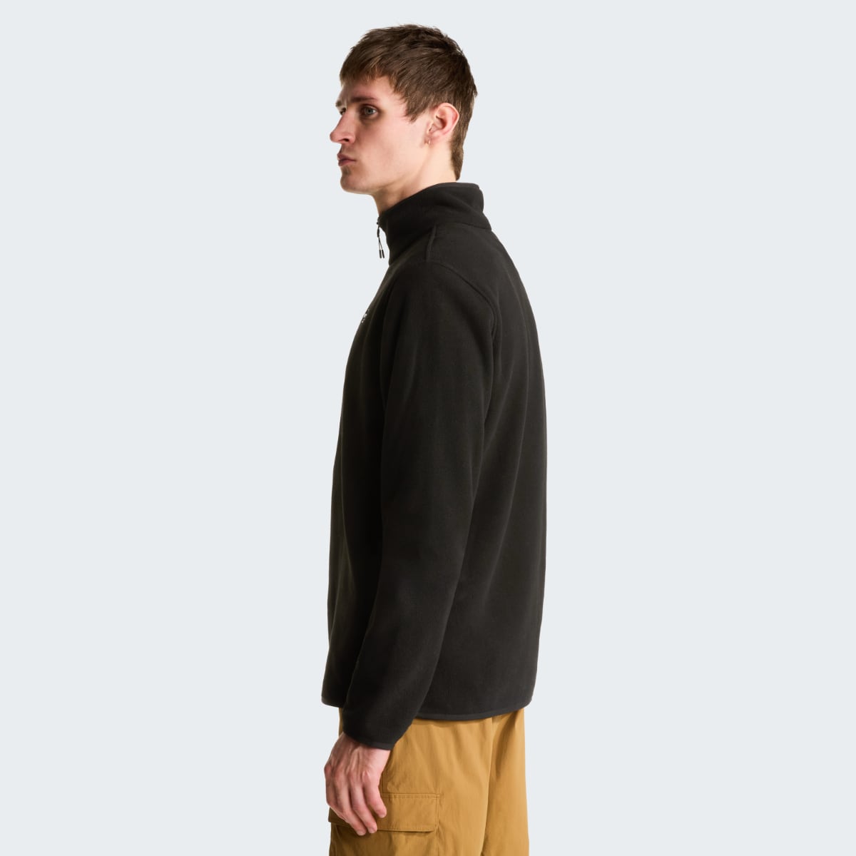 Side profile of a male wearing The North Face Glacier 1/4 Zip fleece in black