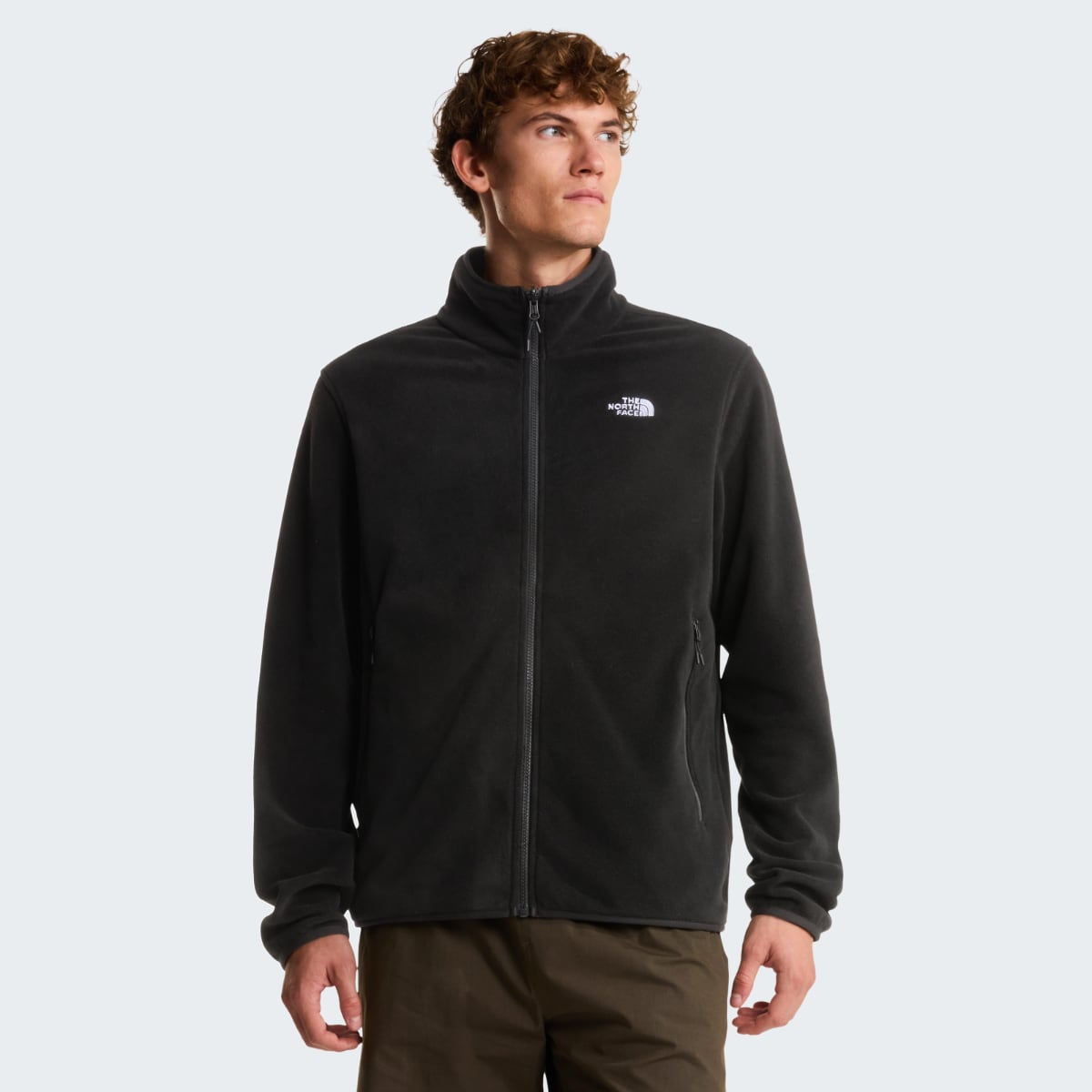 Back view of black Glacier fleece jacket with high collar and small North Face logo on upper back