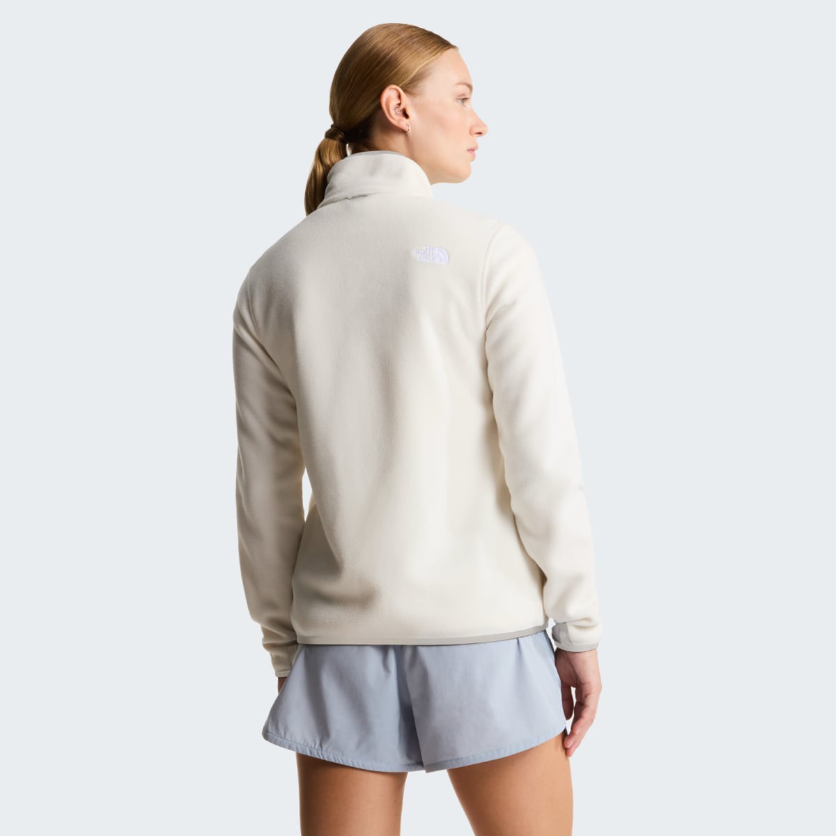 Back view of The North Face Glacier Fleece Women's Jacket in White Dune on a model