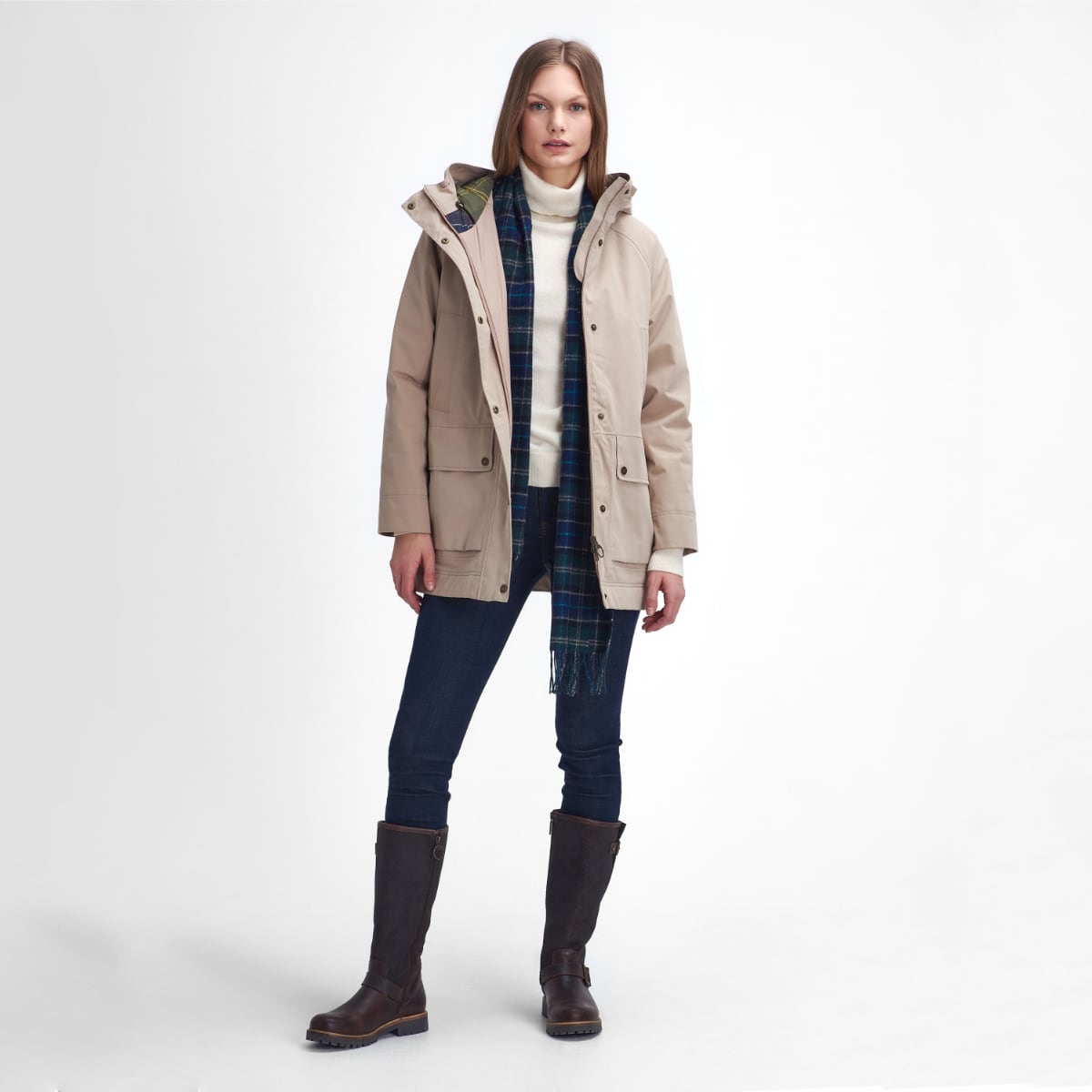 Full length view of Barbour Winter Beadnell waterproof jacket in Sand Dune with scarf jeans and tall boots