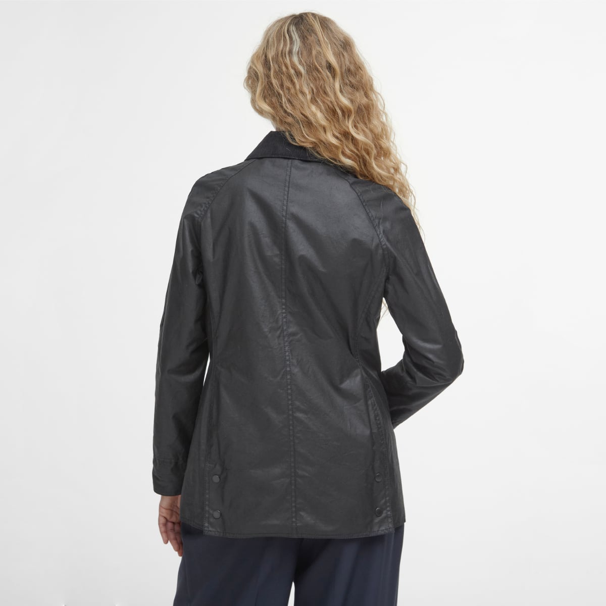 Rear view of Barbour Beadnell wax jacket in black on model