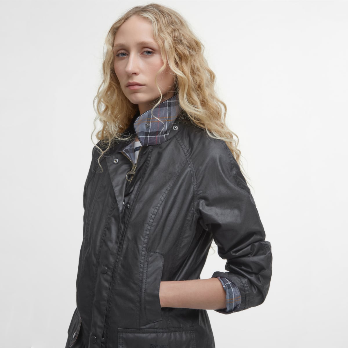 Side profile Barbour Beadnell wax jacket in black on model