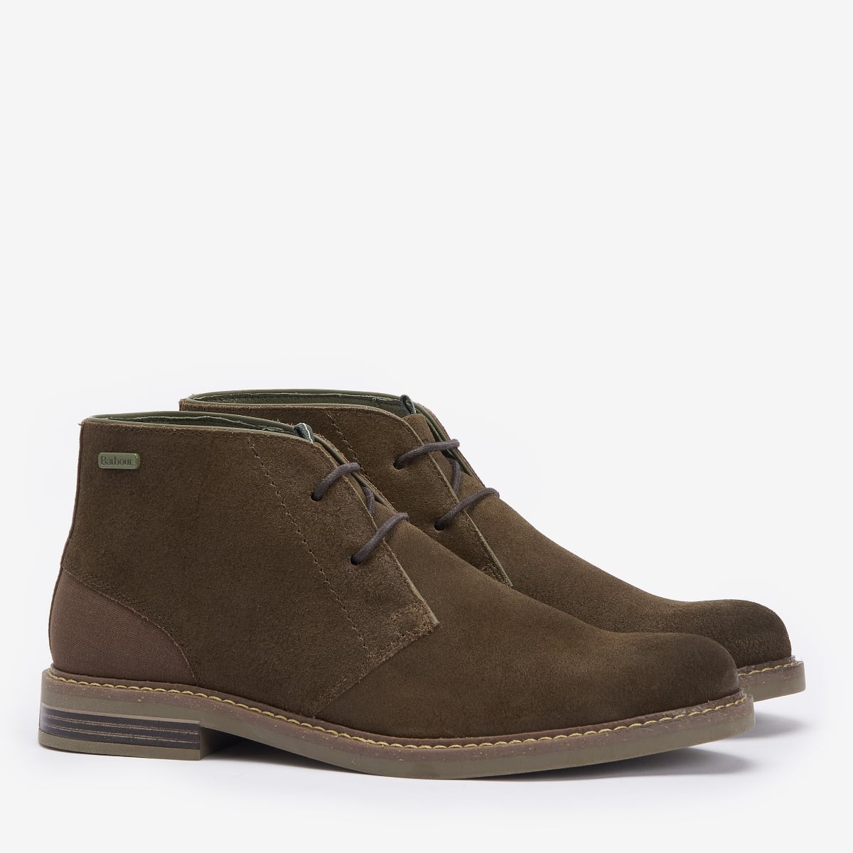 A pair of Barbour Readhead Men's Chukka Boots in khaki color, showcasing the side profile of the boots with laces and the Barbour badge visible.