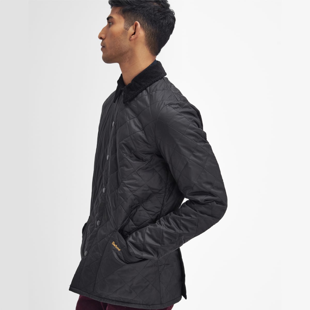 Side profile of Barbour Heritage Liddesdale quilted men’s jacket in black on model