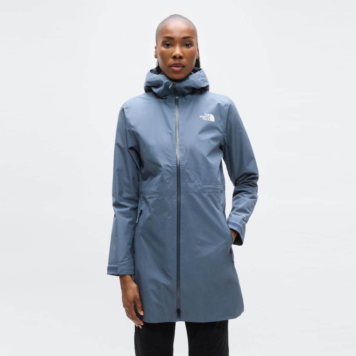 Front view of a woman wearing Granite Grey The North Face Hikesteller Parka with hood and full front zipper.