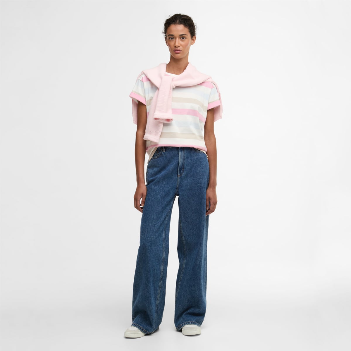 Barbour Lyndale T Shirt in pastel stripes worn by a model with a pink sweater draped over her shoulders