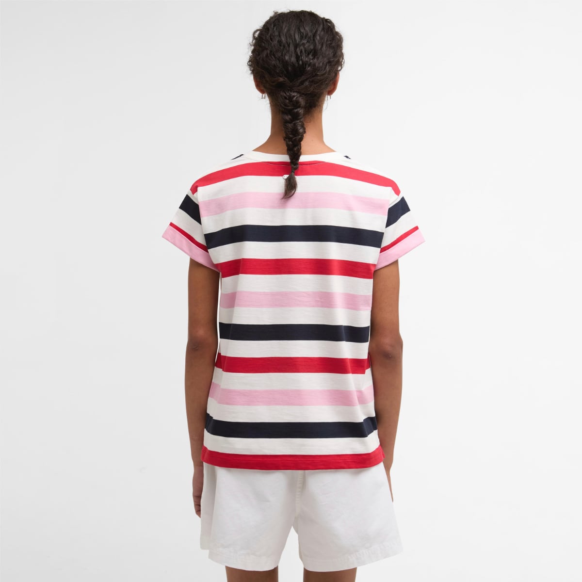 Back view of a woman wearing a Barbour Lyndale T Shirt with red pink and navy horizontal stripes and white shorts