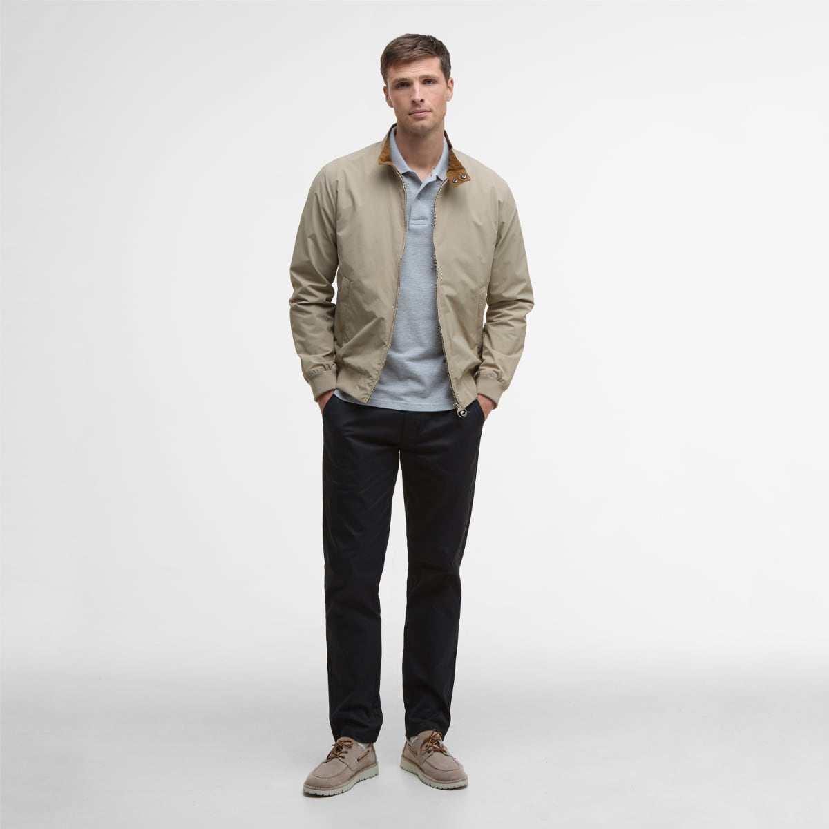 Man wearing Barbour Royston casual jacket in Washed Stone with a light blue polo, front view.