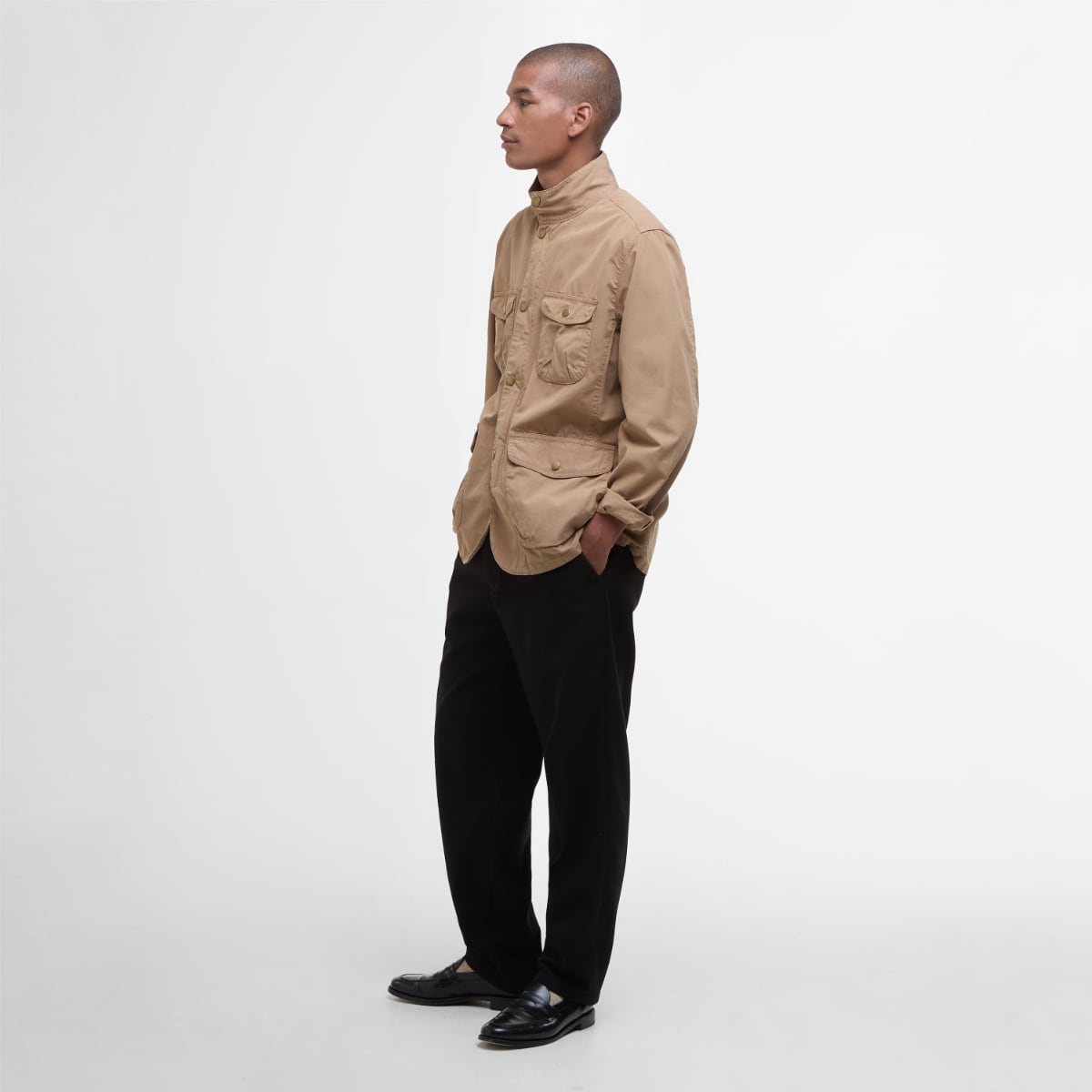 Side view of Barbour Ogston men's casual jacket in stone worn by a model