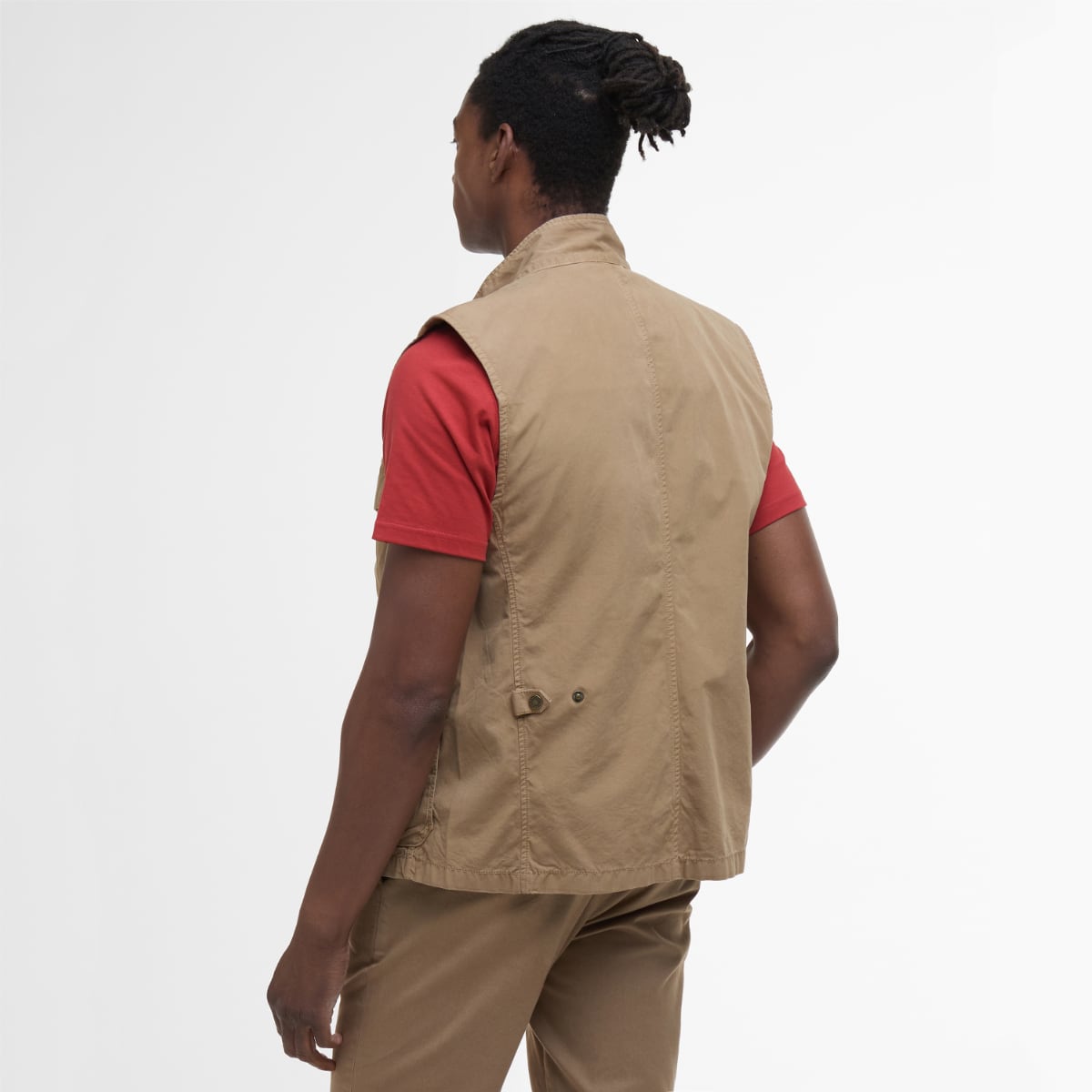 Back view of Barbour Casual Corbridge gilet in stone worn over a red T-shirt.