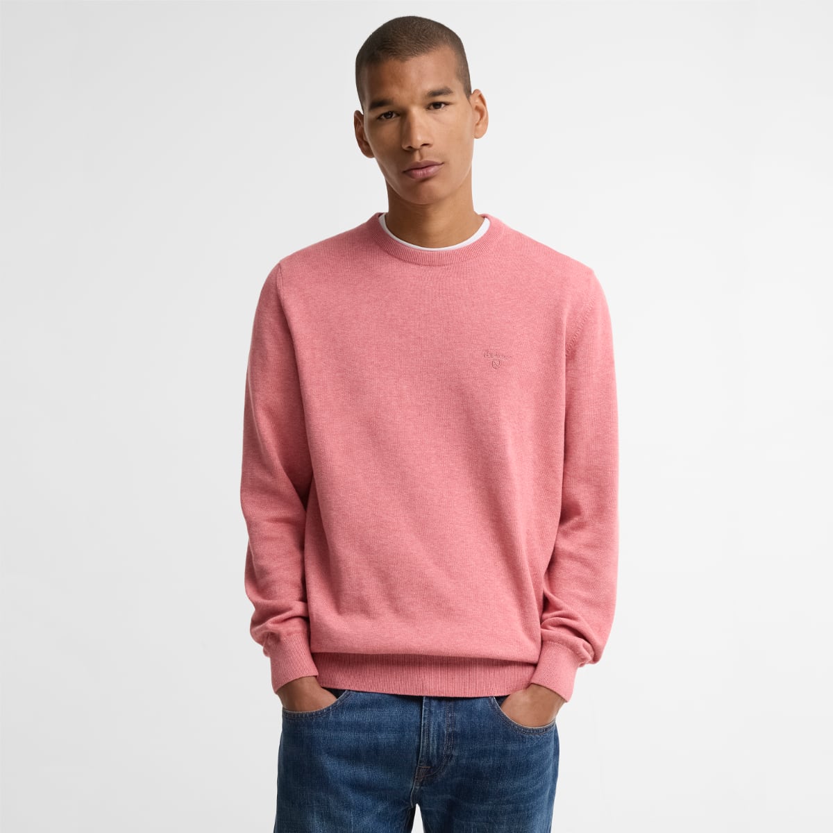 Barbour Pima cotton crew neck jumper in pink clay on male model with blue jeans