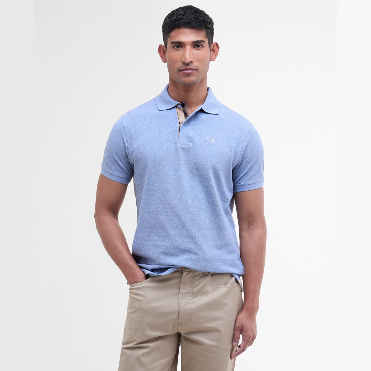 Male model wearing Barbour Tartan Pique polo in sky marl with beige chinos
