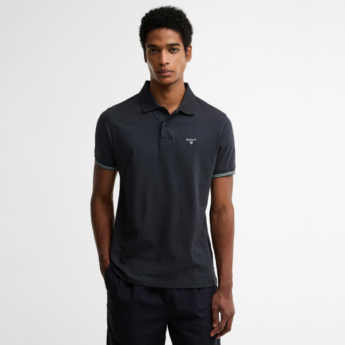 Front view of a male model wearing Barbour Austwick Tailored Polo Shirt in dark navy