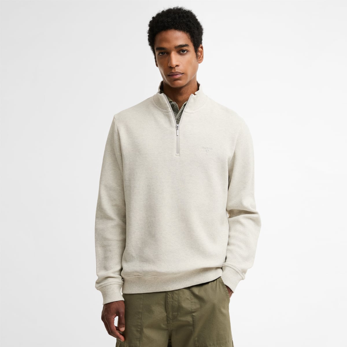 Front view of Barbour Ravensworth half zip sweatshirt in ecru marl worn by a model