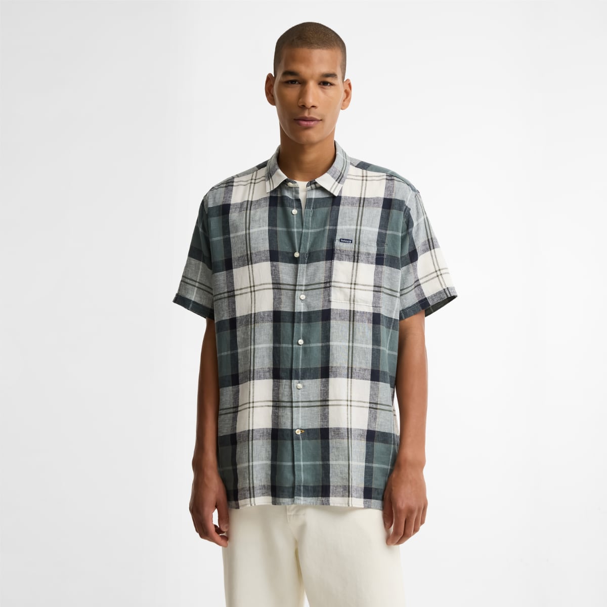 Model wearing Barbour Croft Tartan short-sleeve relaxed-fit shirt in Meadow Brook plaid.