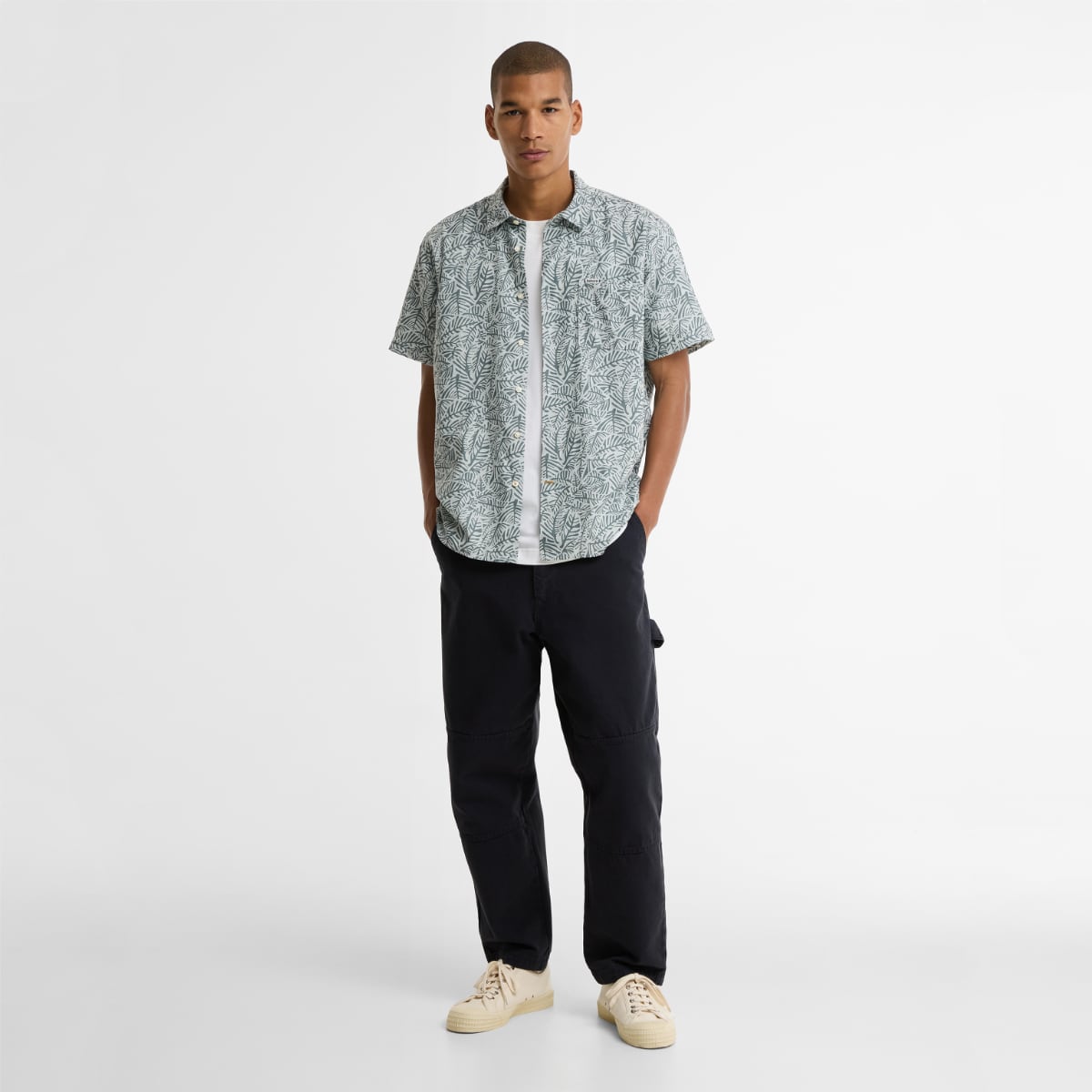 Man wearing Barbour Dearham short sleeve shirt in Dusty Slate with a white T-shirt.