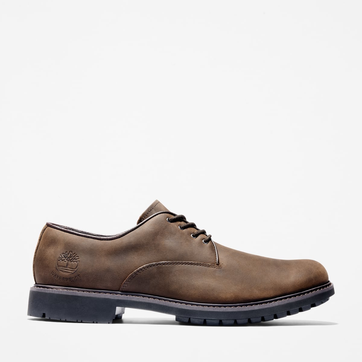 A pair of Timberland Earthkeepers Stormbuck Plain Toe Oxford Men's Shoes in burnished dark brown oiled color. Side view.