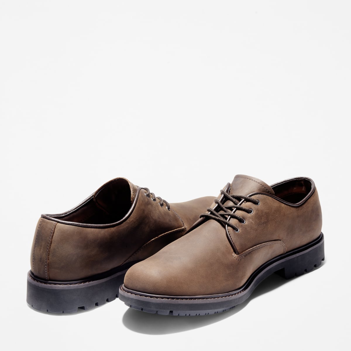 A pair of Timberland Earthkeepers Stormbuck Plain Toe Oxford Men's Shoes in burnished dark brown oiled color.