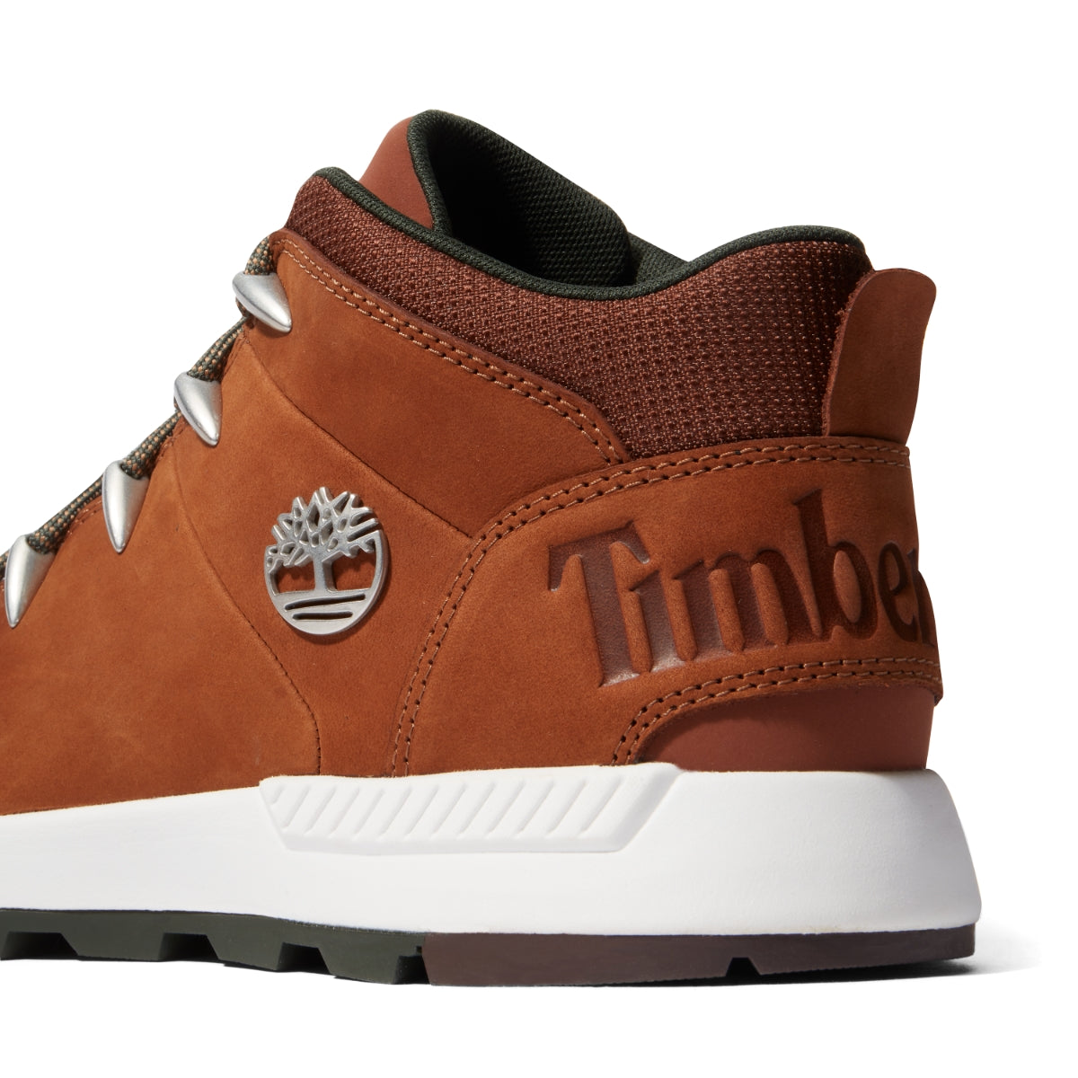 A pair of brown Timberland Sprint Trekker Mid Men's Boots with lace-up closure, featuring a leather upper, fabric lining, and rubber outsoles. Rear 3/4 view.