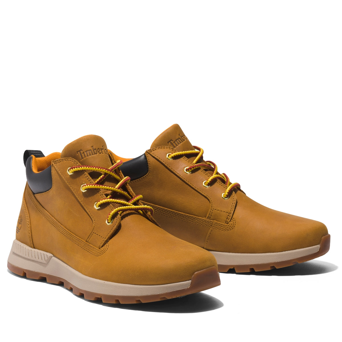 A pair of Timberland Killington Trekker Low Chukka Men's Boots in wheat color, featuring a lace-up closure, with the Timberland logo visible on the heel outer side.