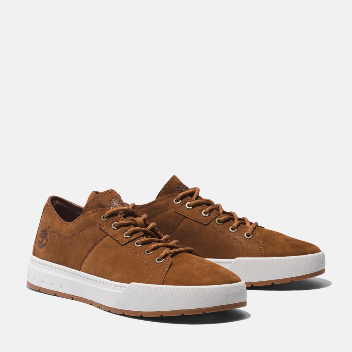 A pair of brown Timberland Maple Grove Low Men's Shoes with a lace-up closure and a rubber outsole.