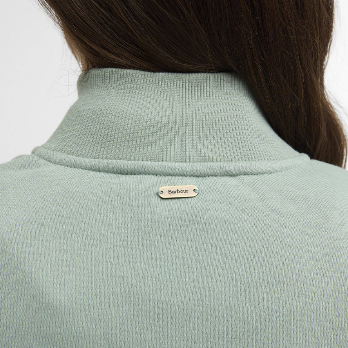 Back view of Barbour Cynthia Quarter-Zip jumper in sage blue with a small metal Barbour tag on the upper back