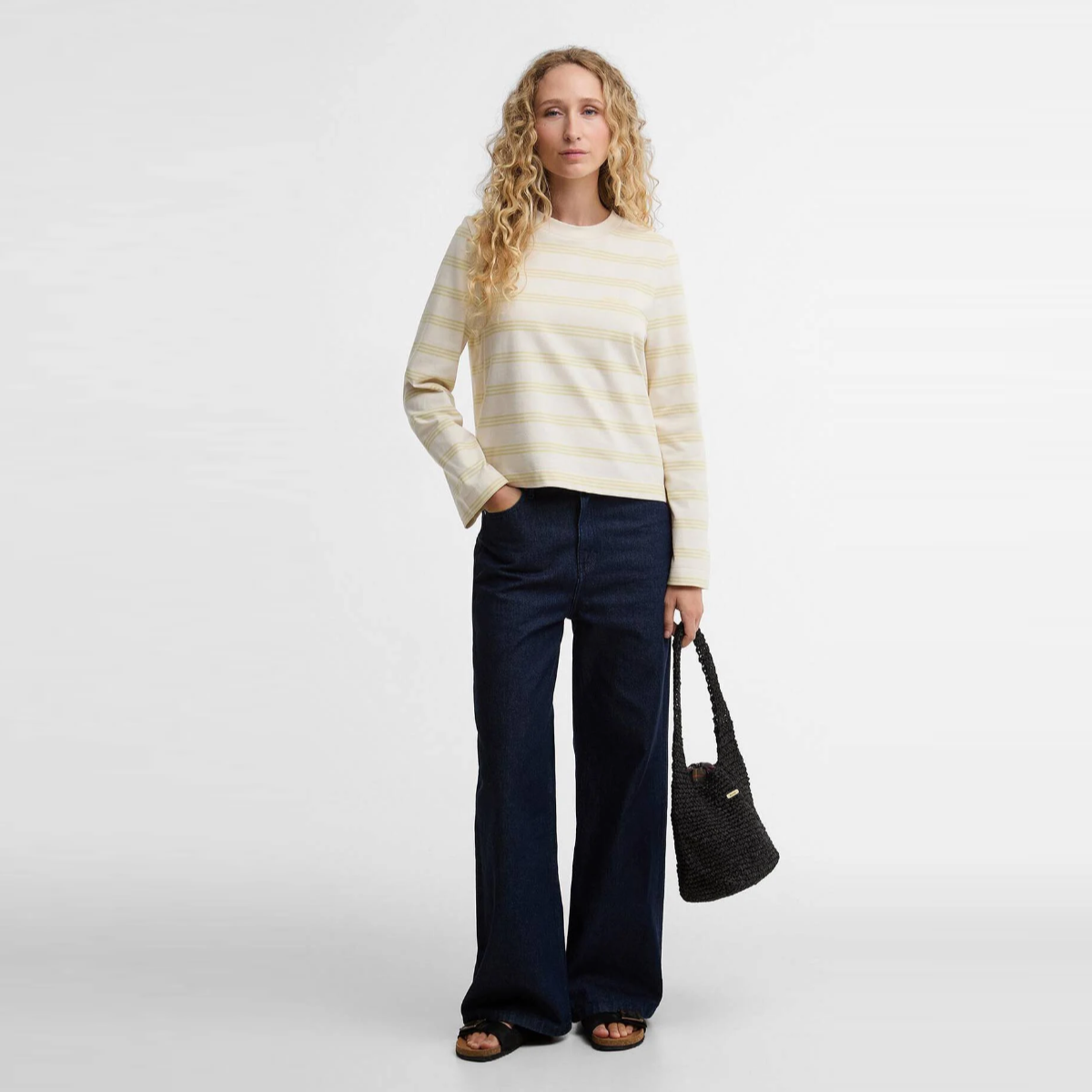 Barbour Dartmoor striped women's top in Original Ecru Soured Citrus worn with dark jeans and a black woven bag.