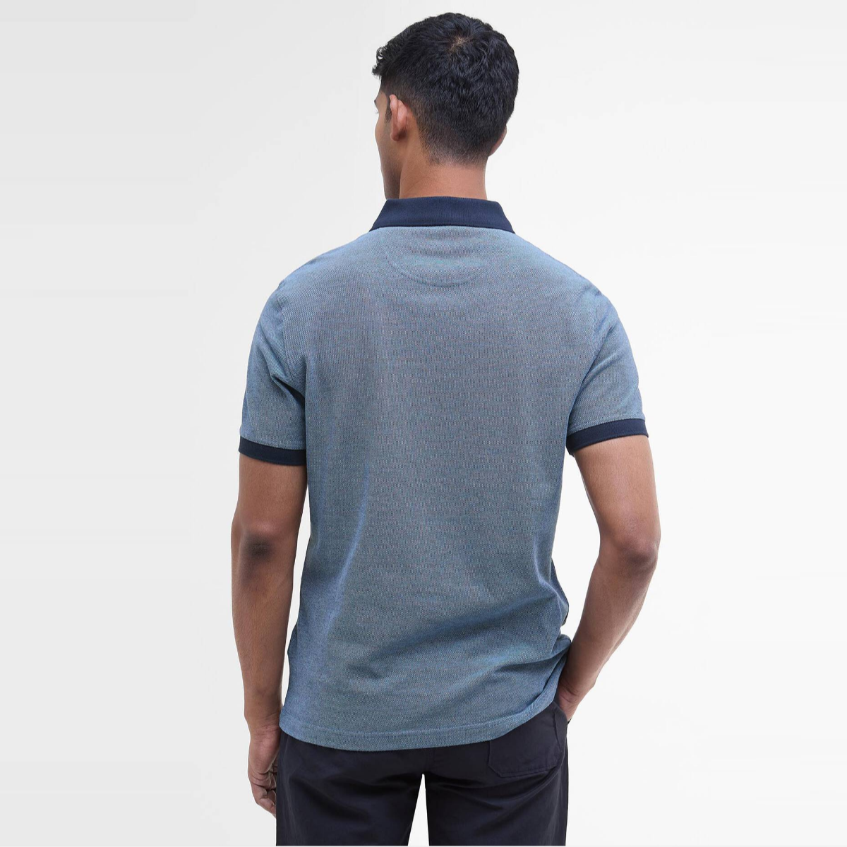 Back view of a man wearing Barbour Essential Sports Mix polo in Classic Navy with navy collar and cuffs
