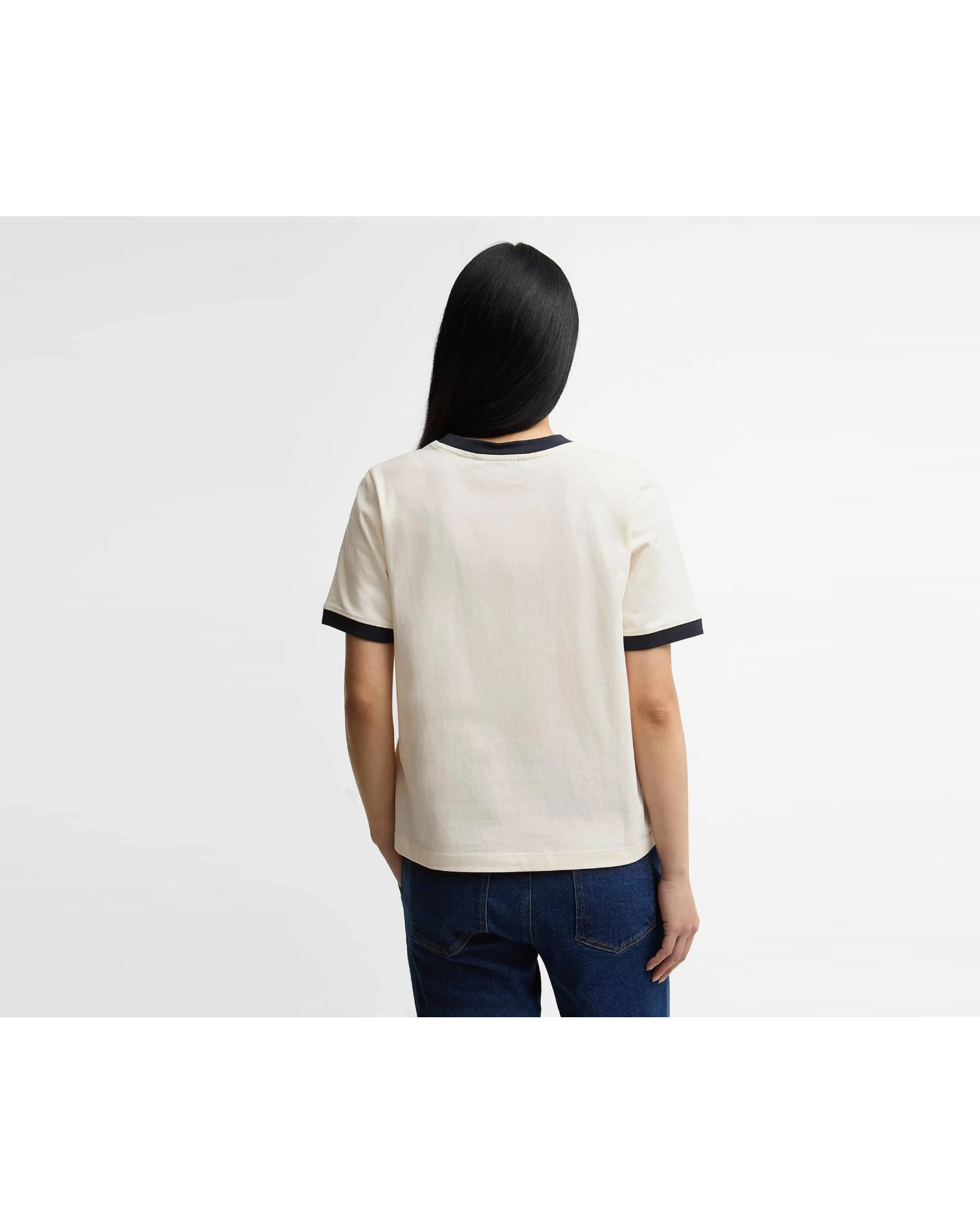 Back view of a model in the Barbour Madeline Tipped T Shirt with navy trim at the collar and cuffs and dark jeans.