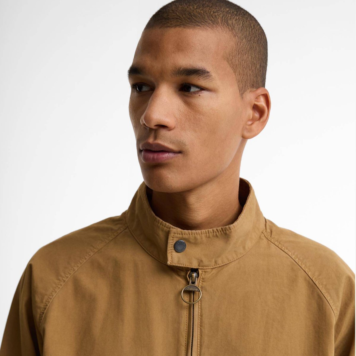 Close-up of Barbour Royston camel Harrington jacket showing stand collar and ring zip pull