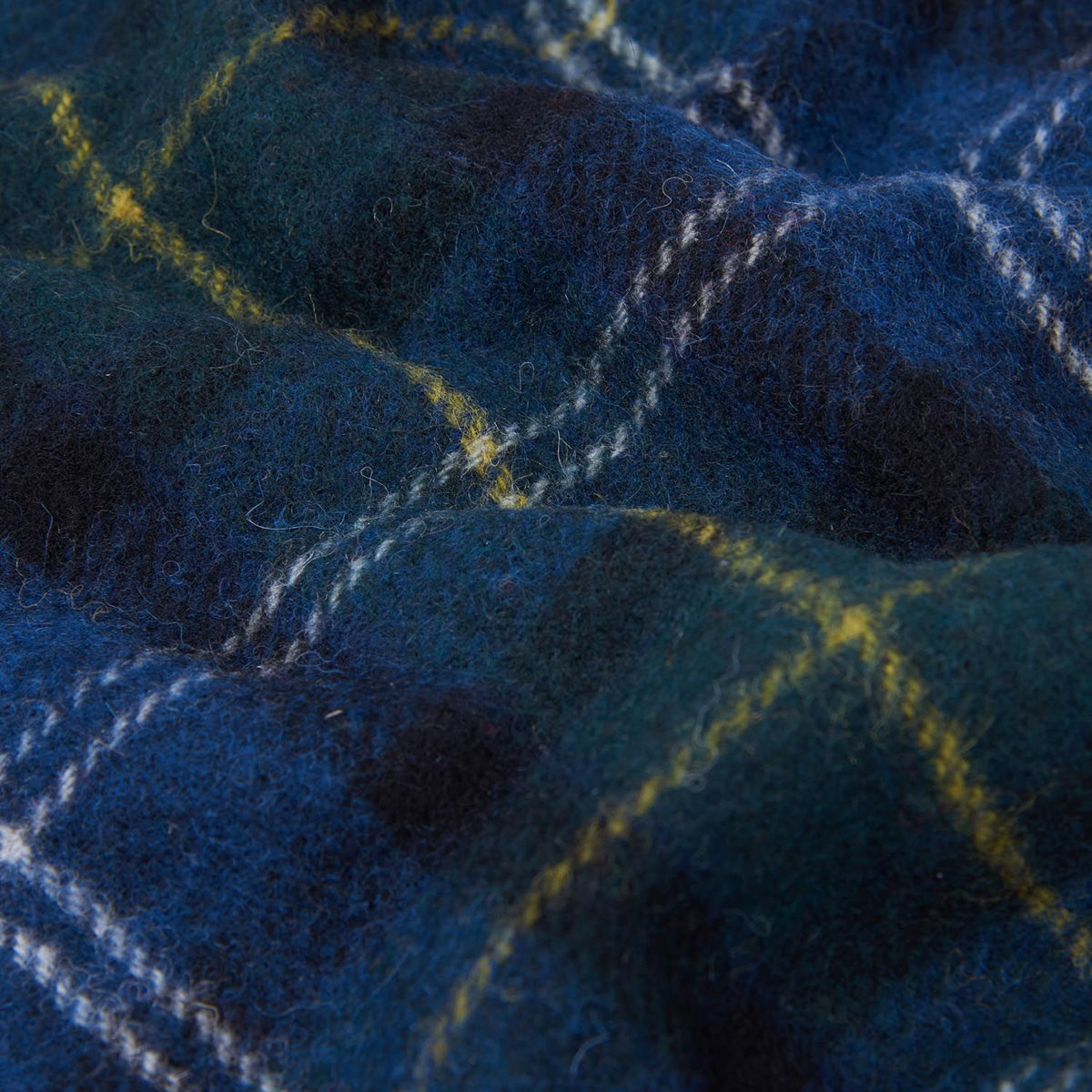 Close up of Barbour tartan lambswool fabric showing blue plaid with yellow lines