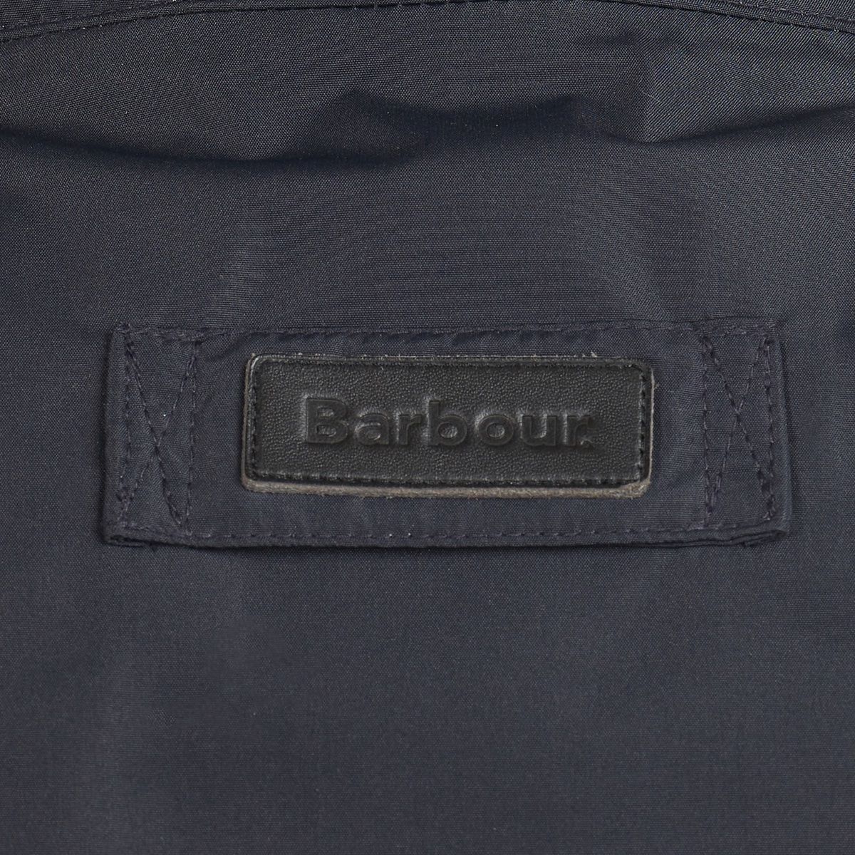 Barbour logo patch sewn on navy jacket fabric