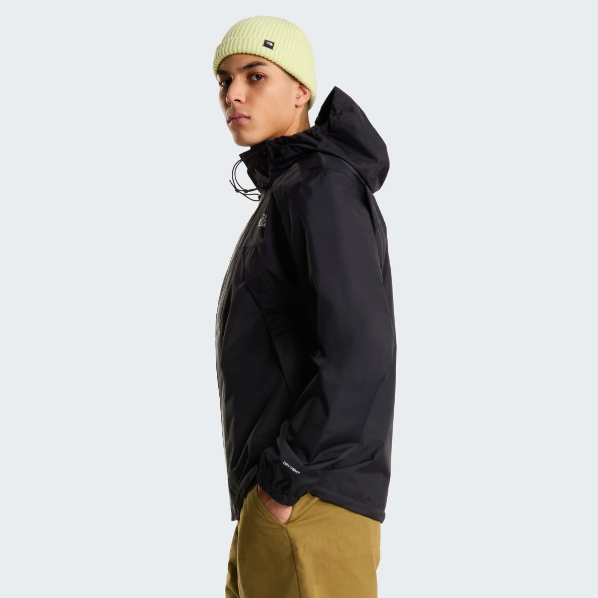Side view of male model in black The North Face Antora waterproof jacket with hood up.