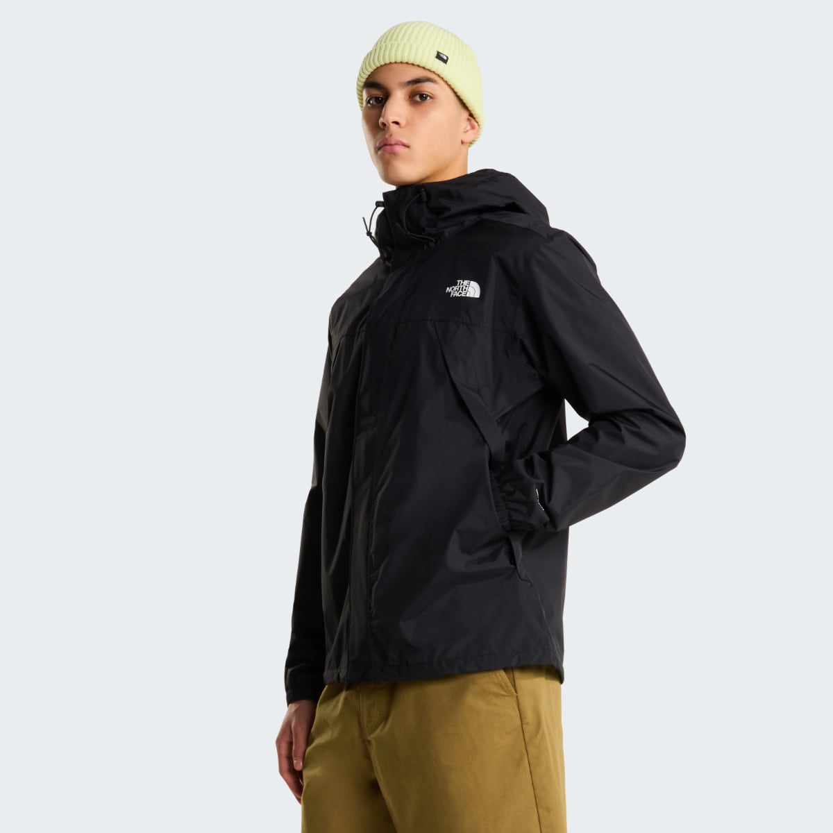 Male model wearing black The North Face Antora waterproof jacket with hood against a light background.