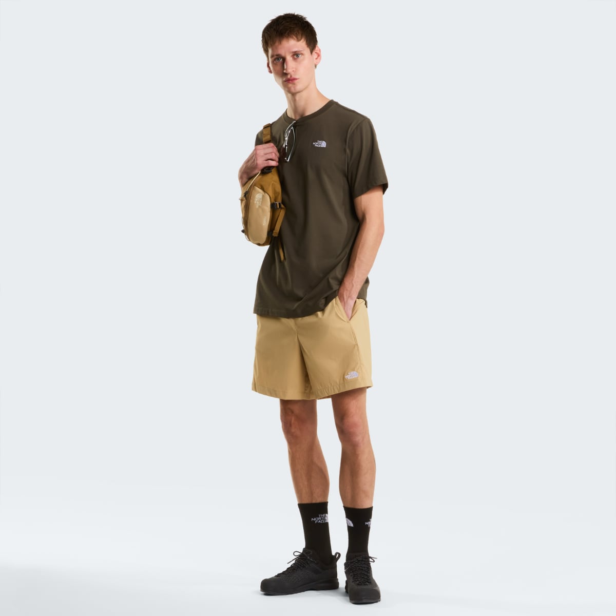 Male model wearing New Taupe Green The North Face Evolution Simple Dome short sleeve T shirt with chest logo