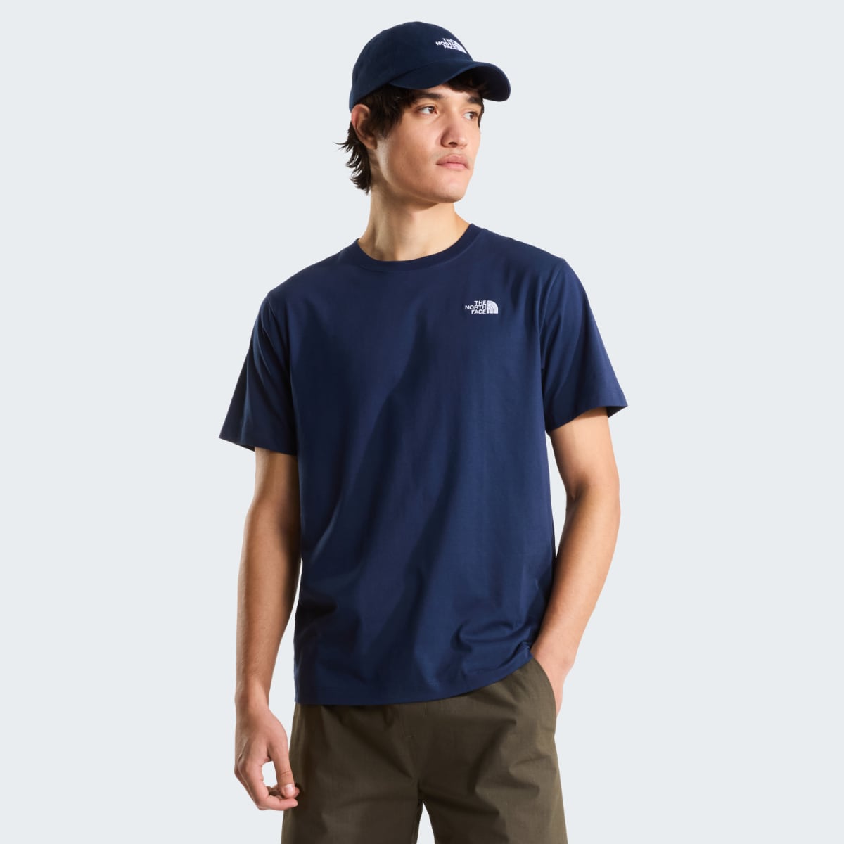 Front view of a male model wearing Summit Navy Evolution Simple Dome short sleeve t shirt with a cap.