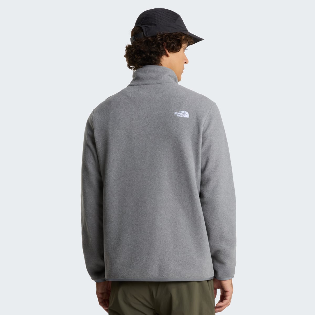 Back view of a model wearing The North Face Glacier fleece in mid grey heather with a small back logo.