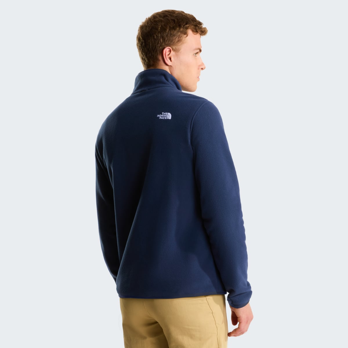Back view of a man wearing navy The North Face Glacier fleece jacket with logo on the upper back