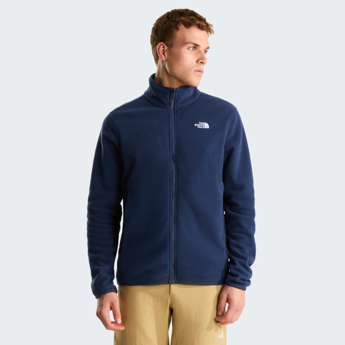 Model wearing The North Face Glacier fleece jacket in Summit Navy, full zip navy fleece with logo on the left chest