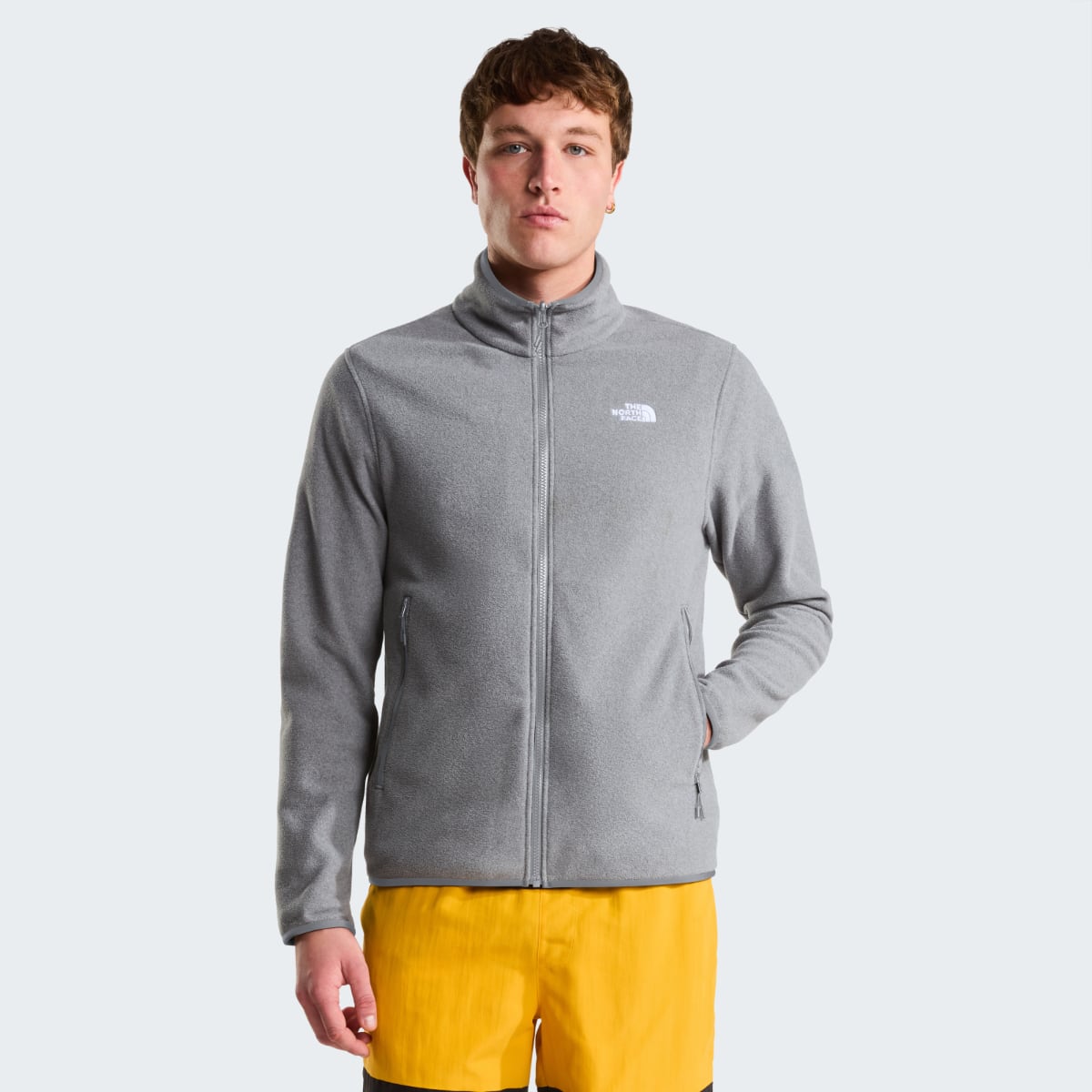 Model wearing grey The North Face Glacier Fleece jacket with zip front and small logo on chest