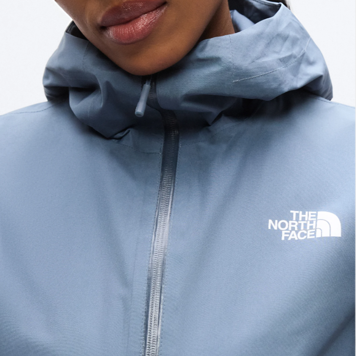 Close-up of The North Face Hikesteller Parka in Granite Grey with front zipper and chest logo.