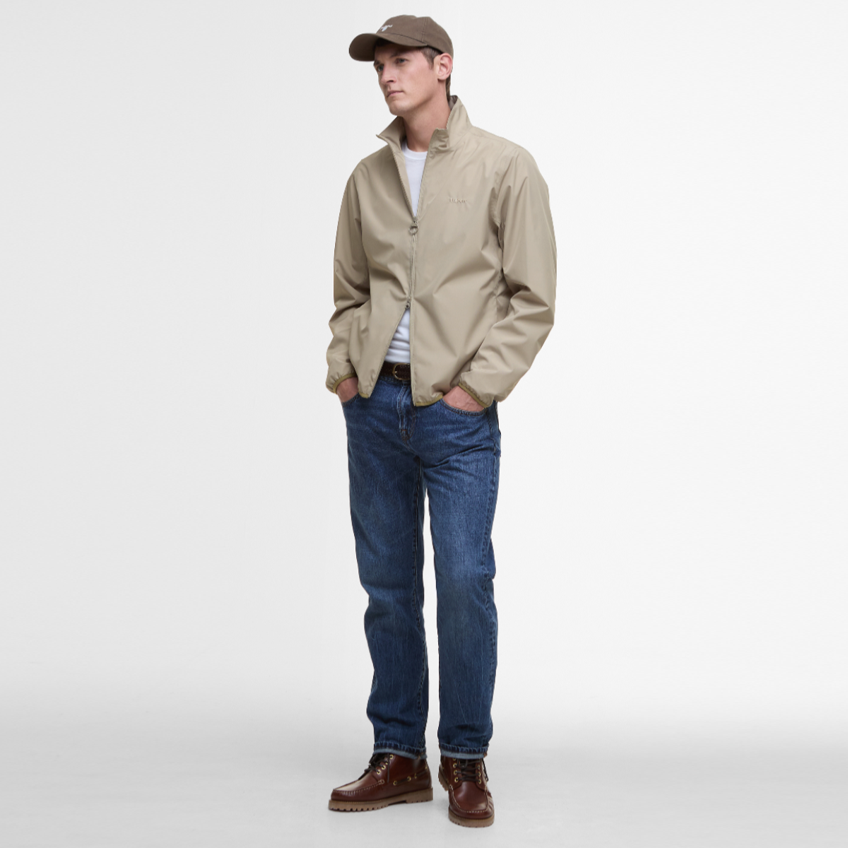 Man wearing Barbour Korbel Waterproof Jacket Washed Stone with hands in pockets