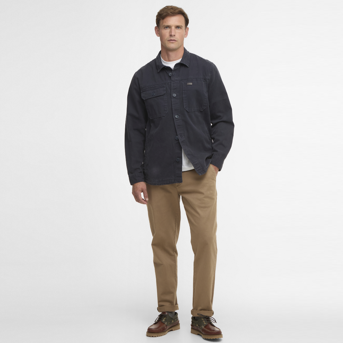 Model wearing navy Barbour Lingfield Canvas Overshirt over a white tee with tan chinos