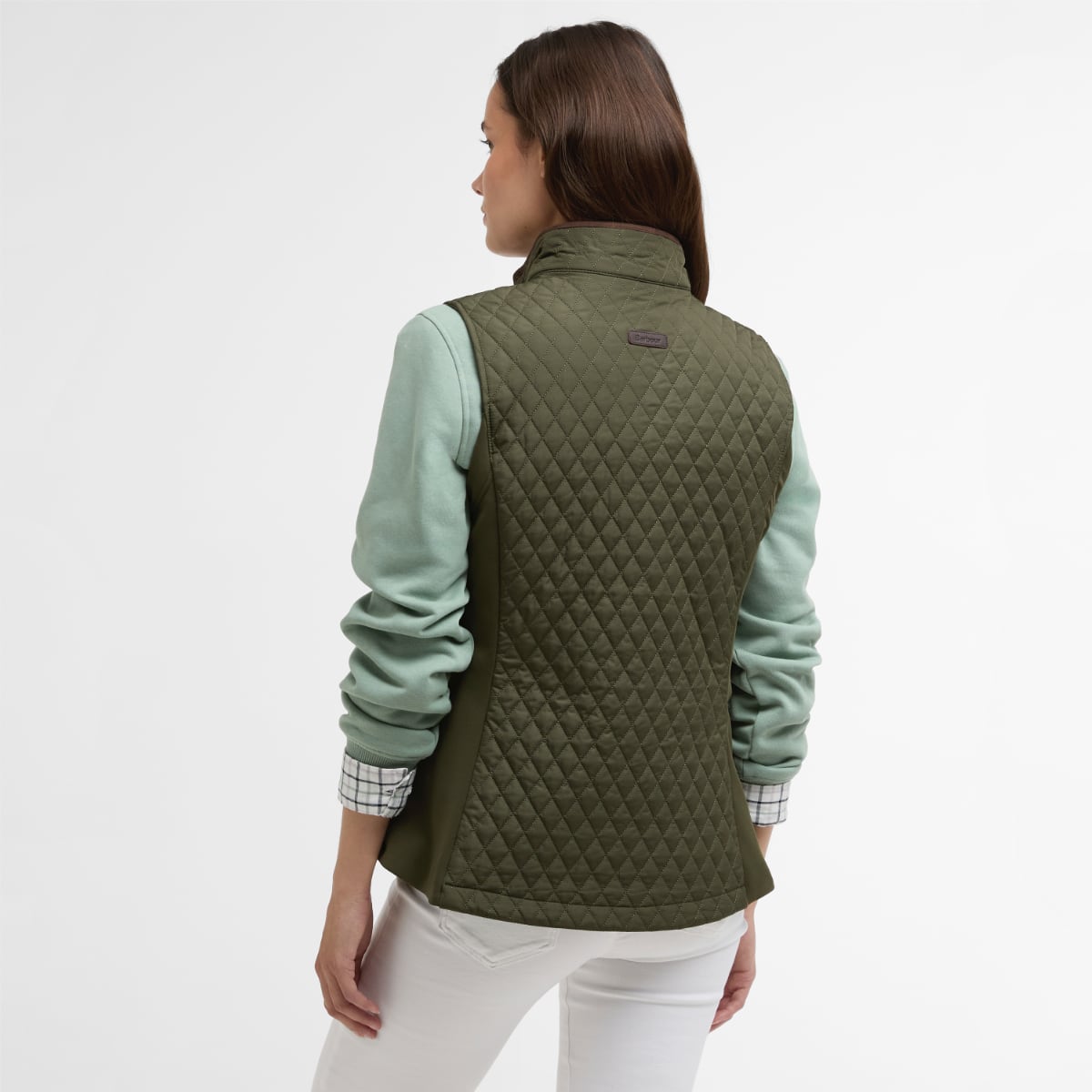 Back view of Barbour Basswood olive quilted gilet worn over a plaid shirt