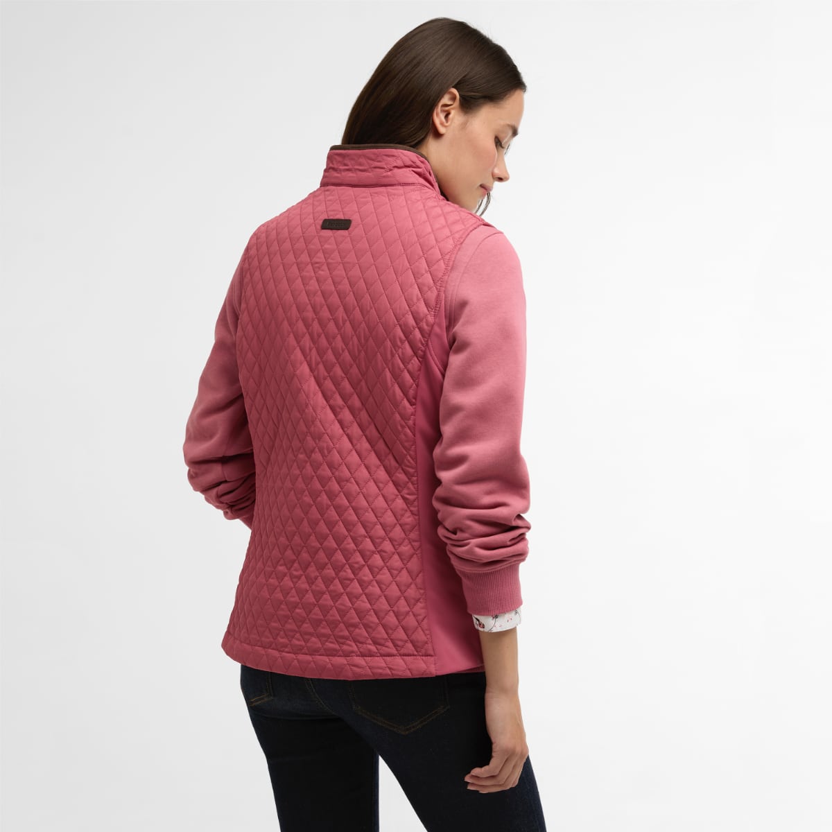 Back view of Barbour Basswood women's quilted gilet in Wild Berry with diamond quilting and a small brand plaque on the upper back.