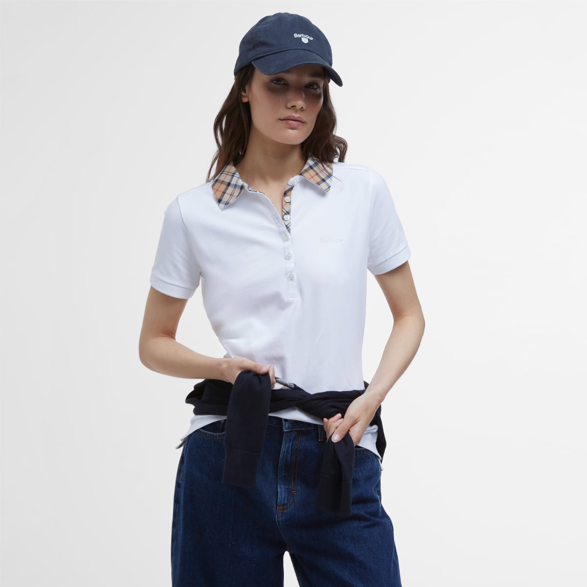 Model wearing Barbour Malvern Polo Shirt Women's in white with plaid collar and dark jeans