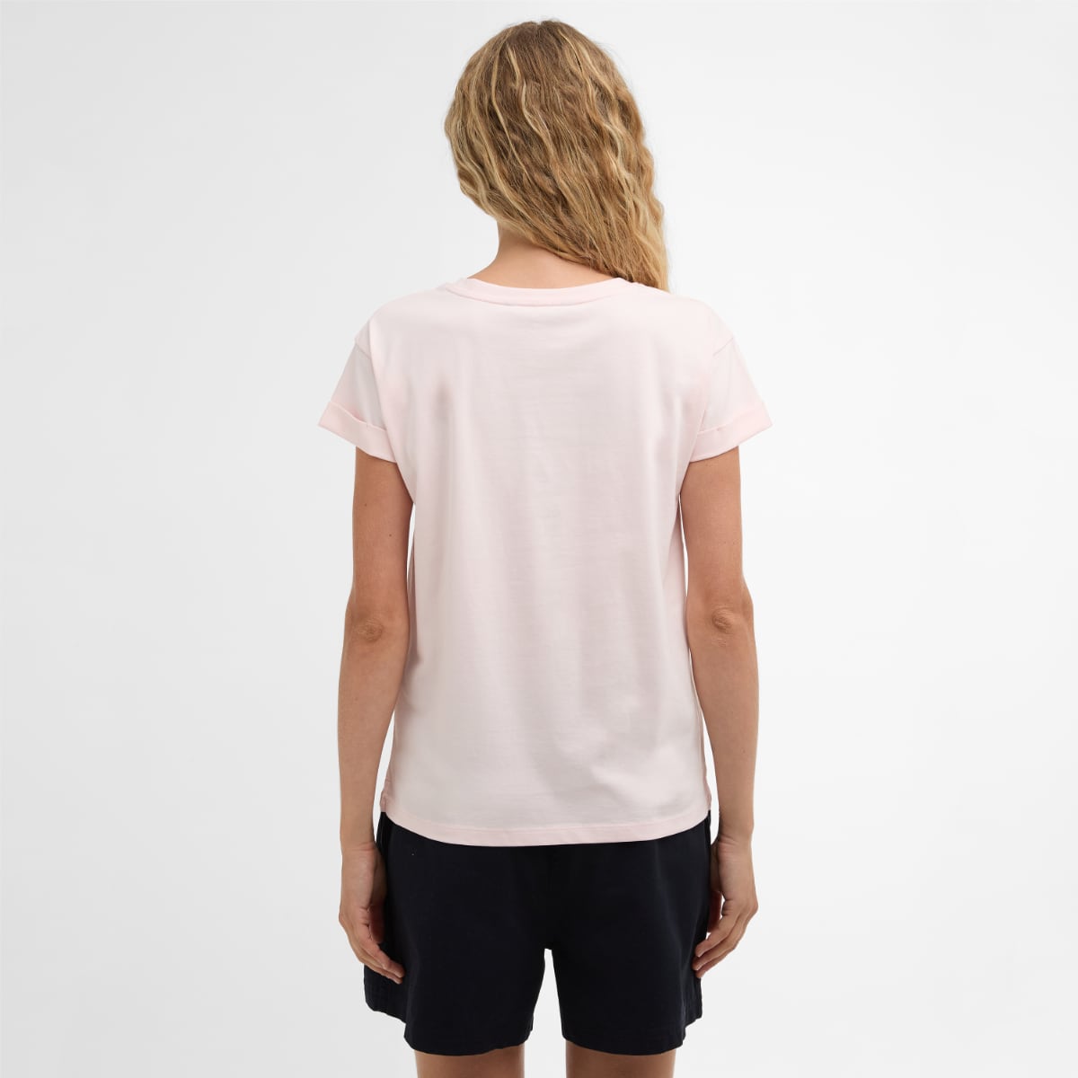 Back view of pale pink Barbour Bede T-Shirt worn by a model with rolled sleeves