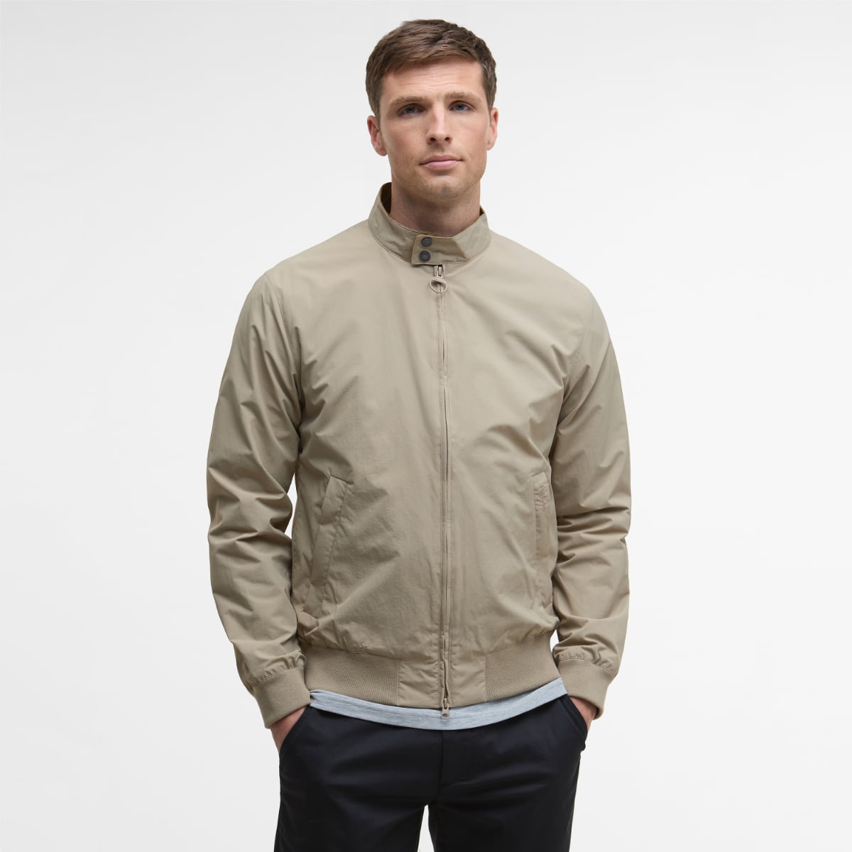 Front view of Barbour Royston Casual Jacket in Washed Stone worn by a model with zip front and ribbed hem.