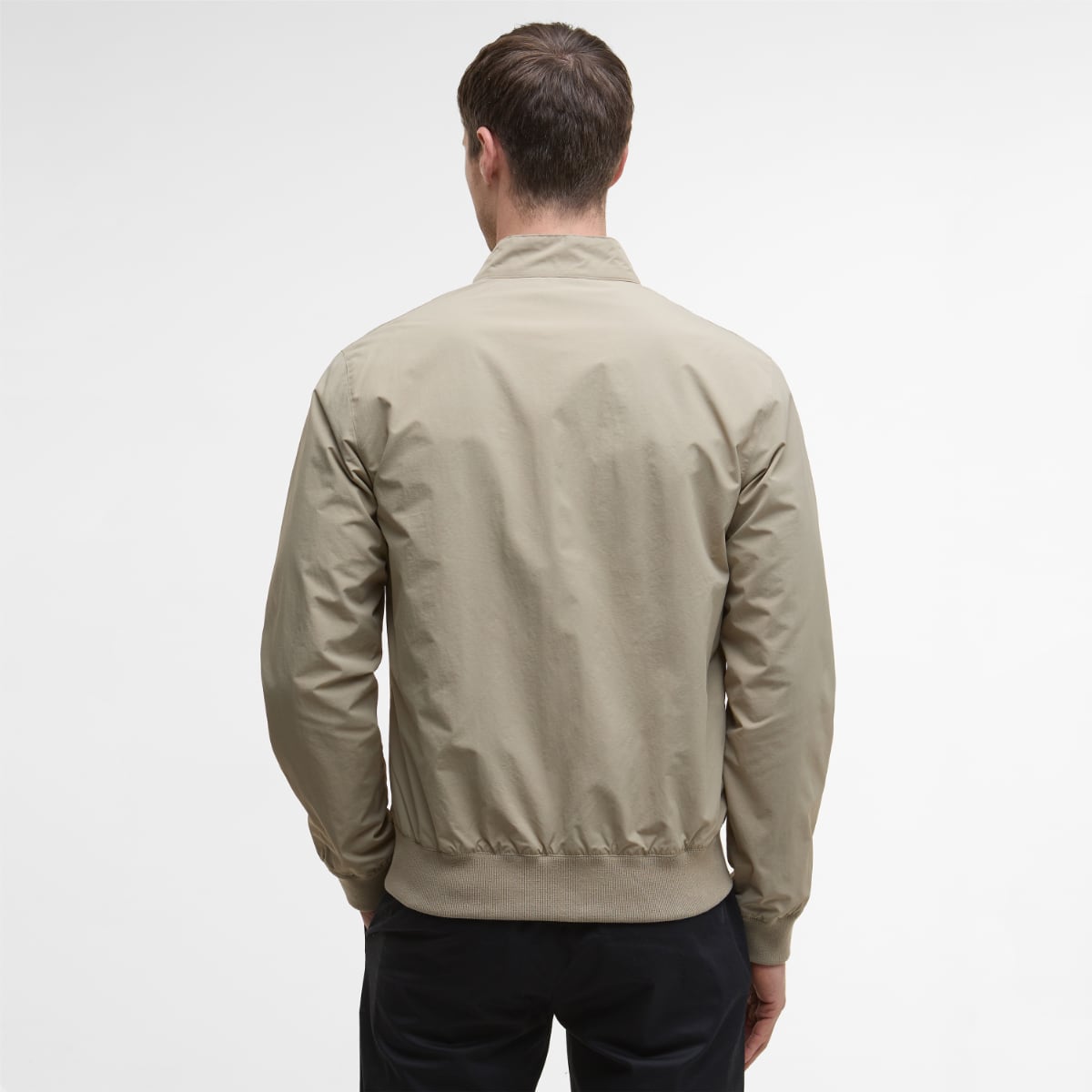Back view of Barbour Royston men's casual jacket in Washed Stone with a ribbed hem