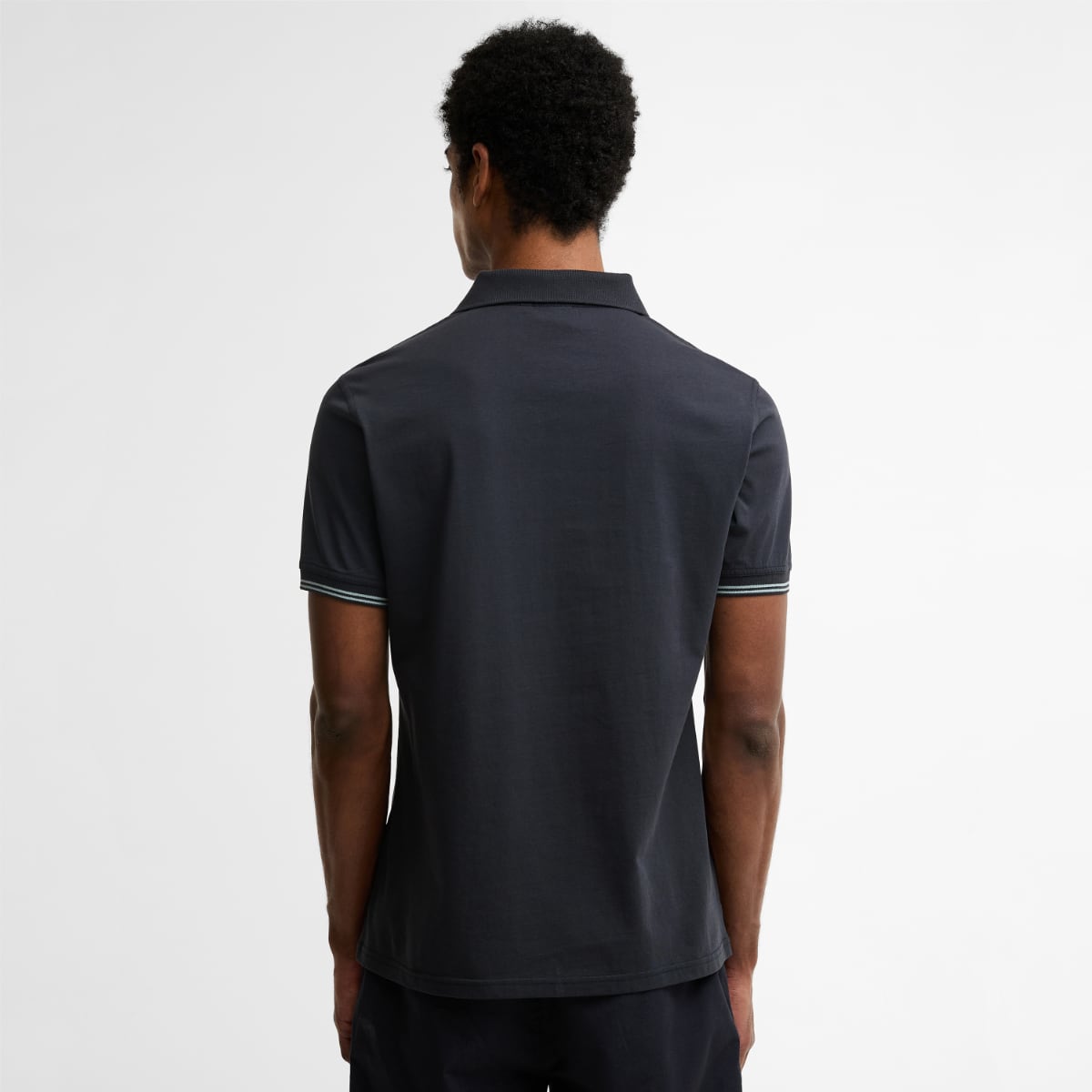 Back view of a dark navy Barbour Austwick polo shirt showing striped sleeve cuffs